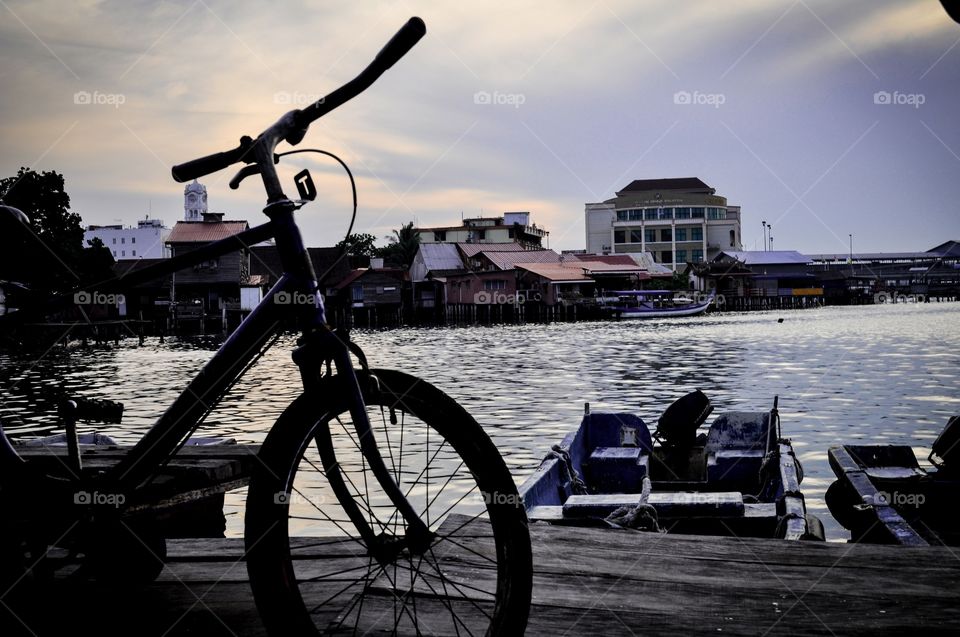 Bicycle, sea, sunrise and boat