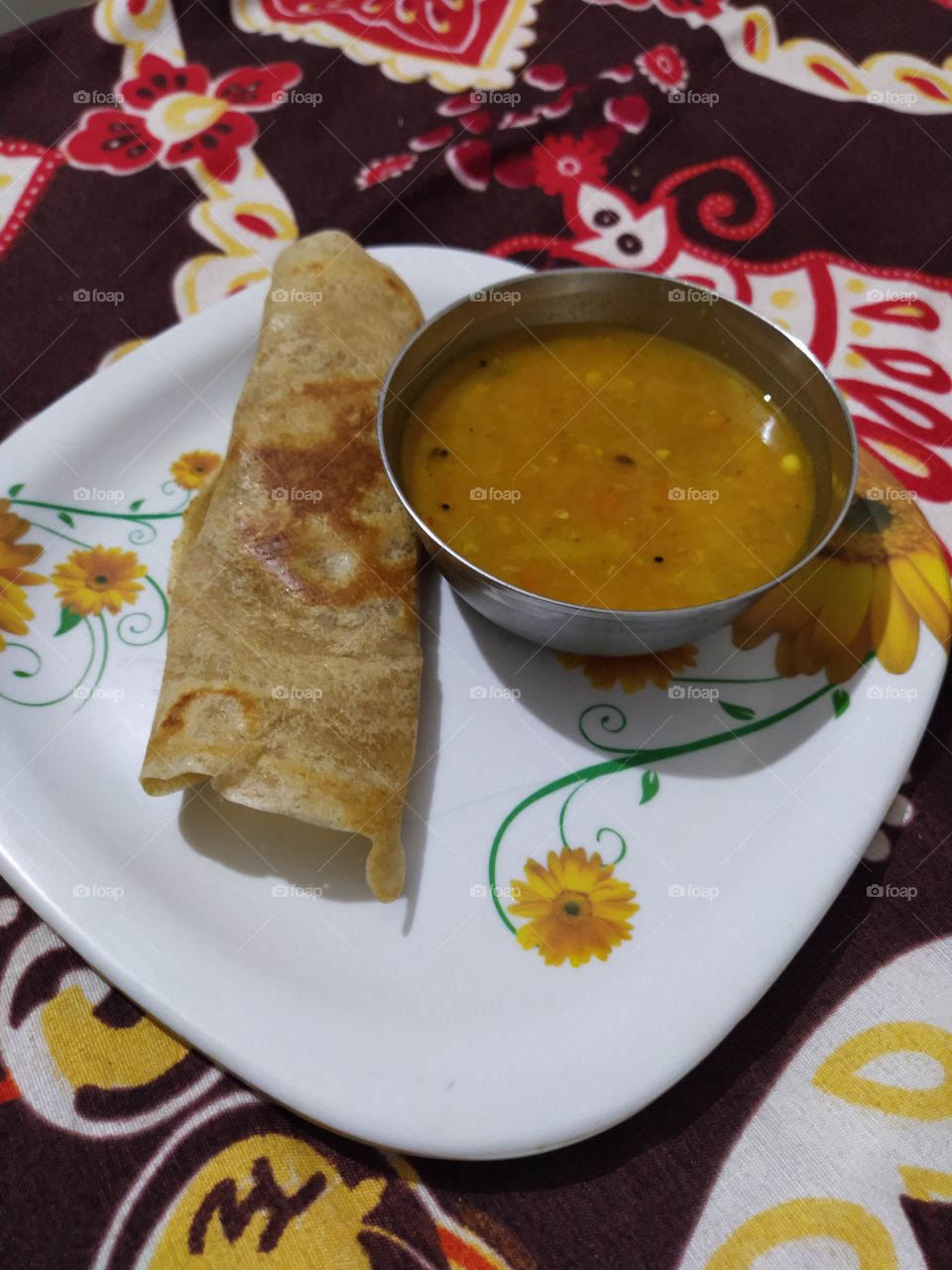 A dosa is a cooked flat thin layered rice batter, originating from the Indian subcontinent, made from a fermented batter. It is somewhat similar to a crepe in appearance. Its main ingredients are rice and black gram ground together in a fine, smooth.