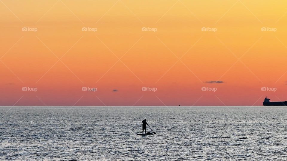 SUP surfing on sunset 