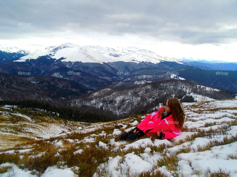 Teenage girl in snowy mountain landscape