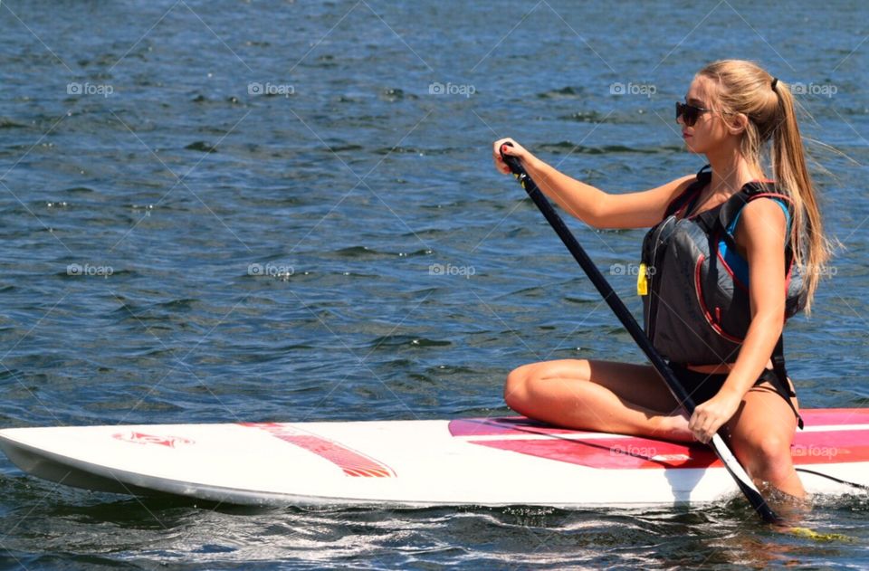Young woman paddle boarding on Lake Dillon
