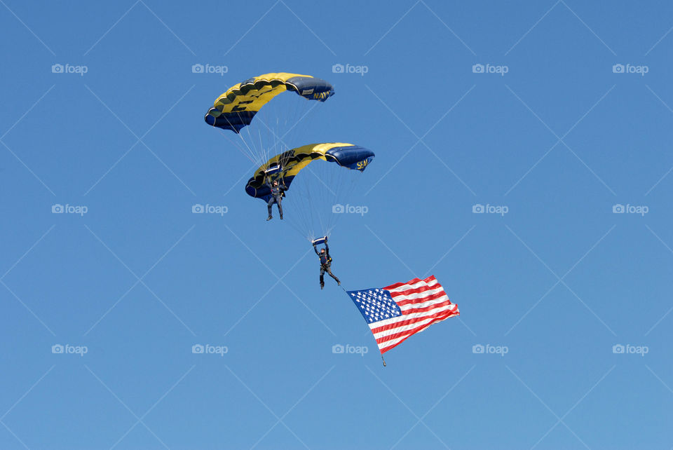 Looking up in sky and watching the US Navy Seals parachute with the American flag!