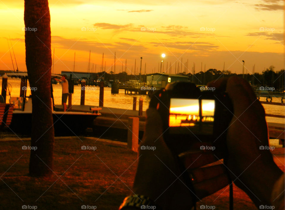 A  golden view through lenses . A shot of the golden sunset at a near by part