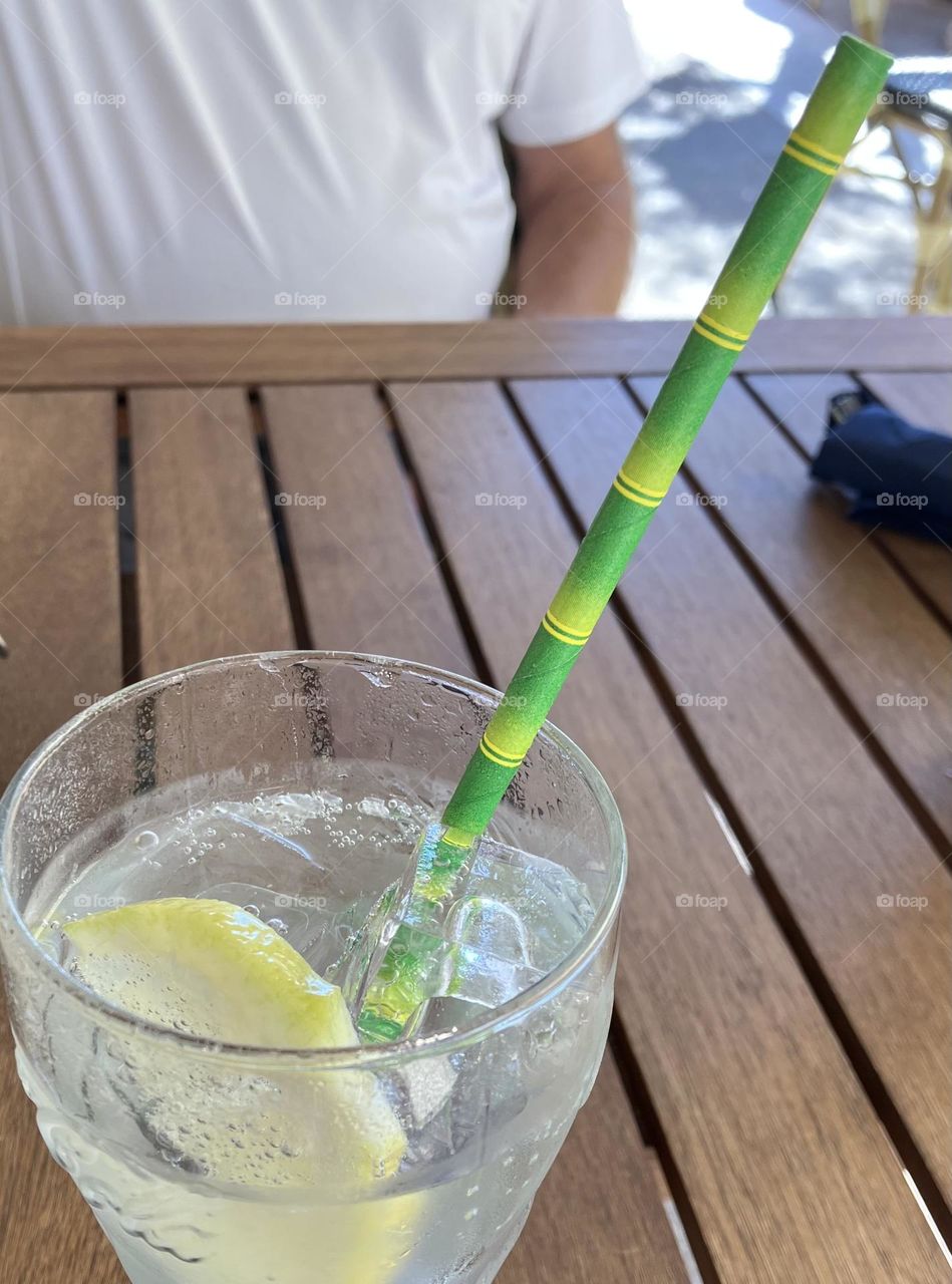 No more plastic : glass with a green cardboard straw imitating bamboo