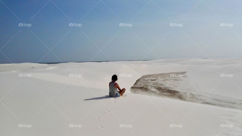 Woman in meditation on desert 