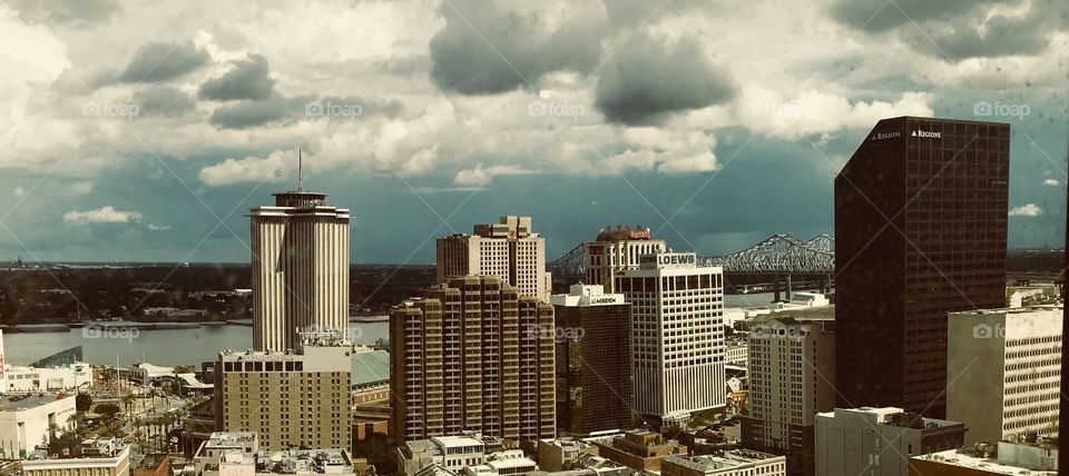 New Orleans downtown views. Billowy clouds. Skyscrapers. Mississippi River. 