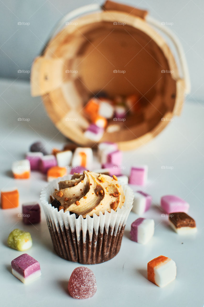 Chocolate cupcake surrounded with colorful candys