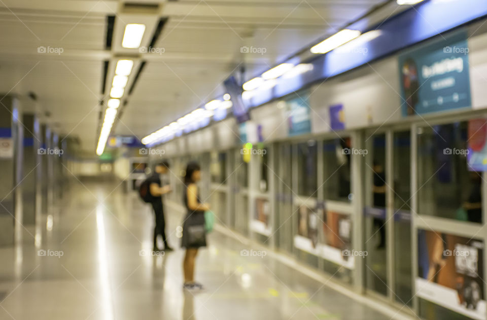 Blurry image of a passenger stand waiting for the subway