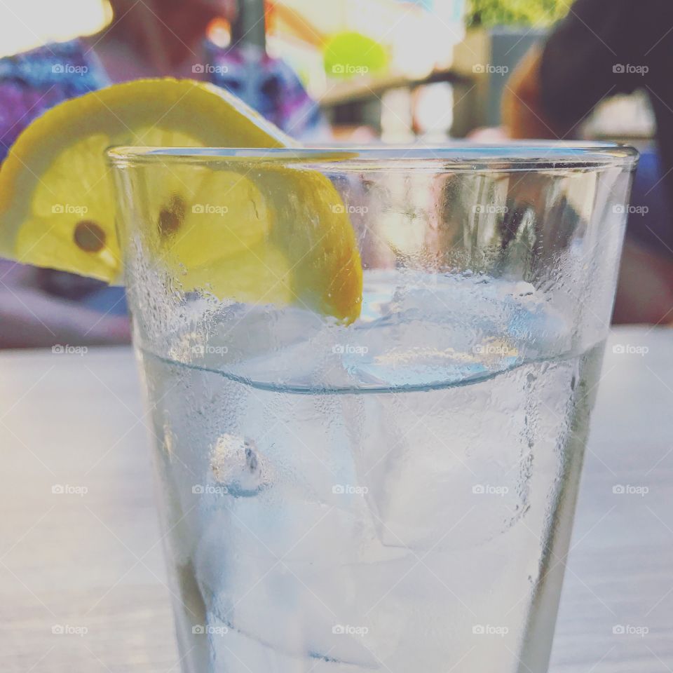 Fresh clear water with a lemon slice in a drinking glass