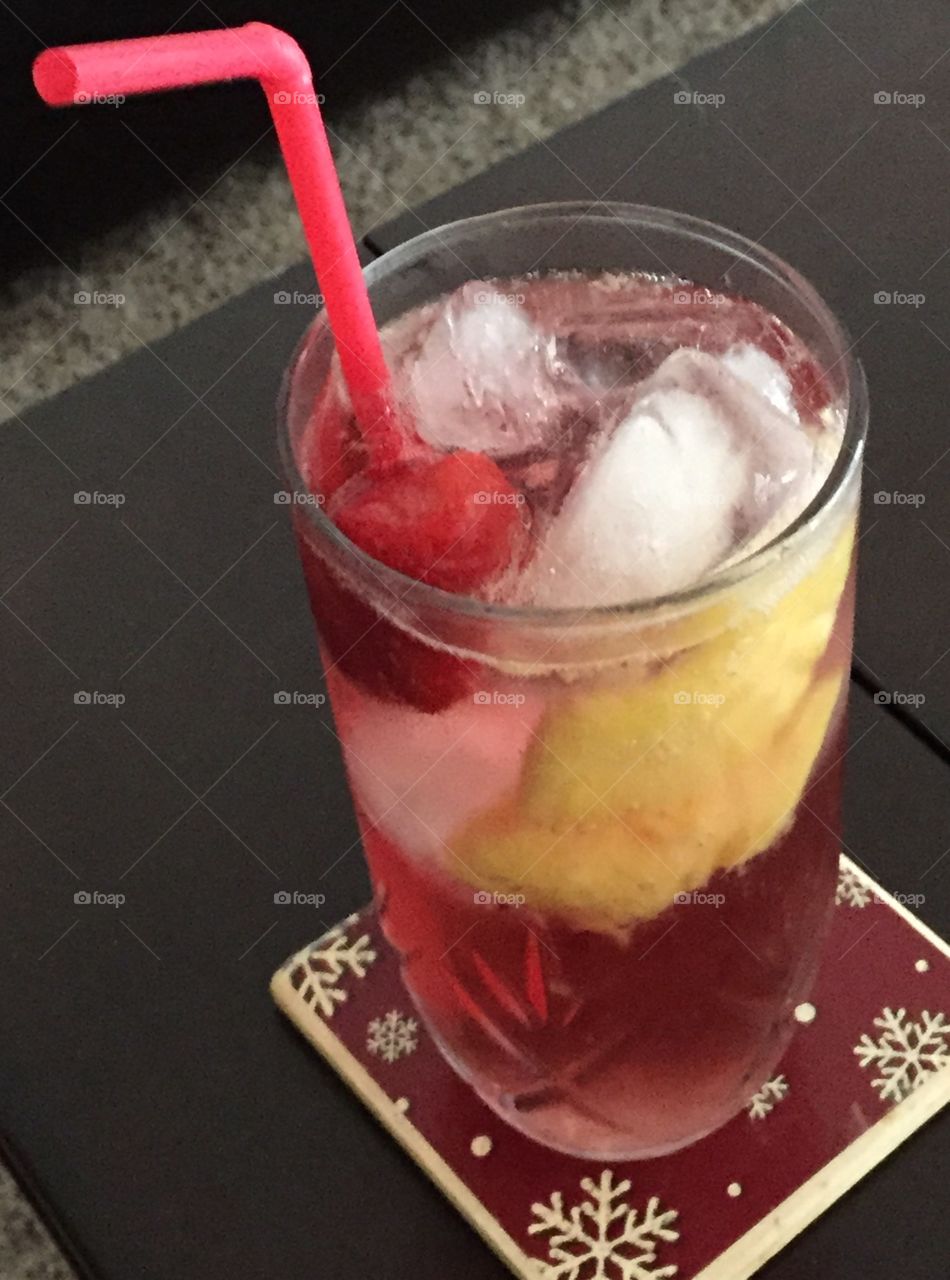 Wine spritzer in a glass with fruit and ice. 