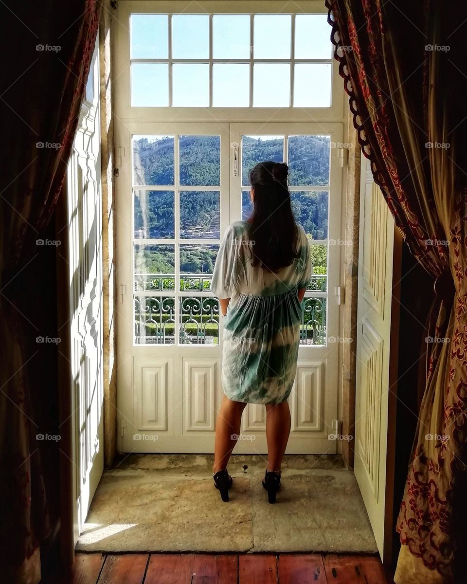 Young woman enjoying a window view