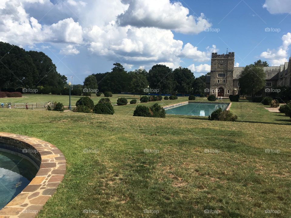 Berry college beautiful campus august summer back to school freshman year orientation sunny day clouds sky tree line pond buildings