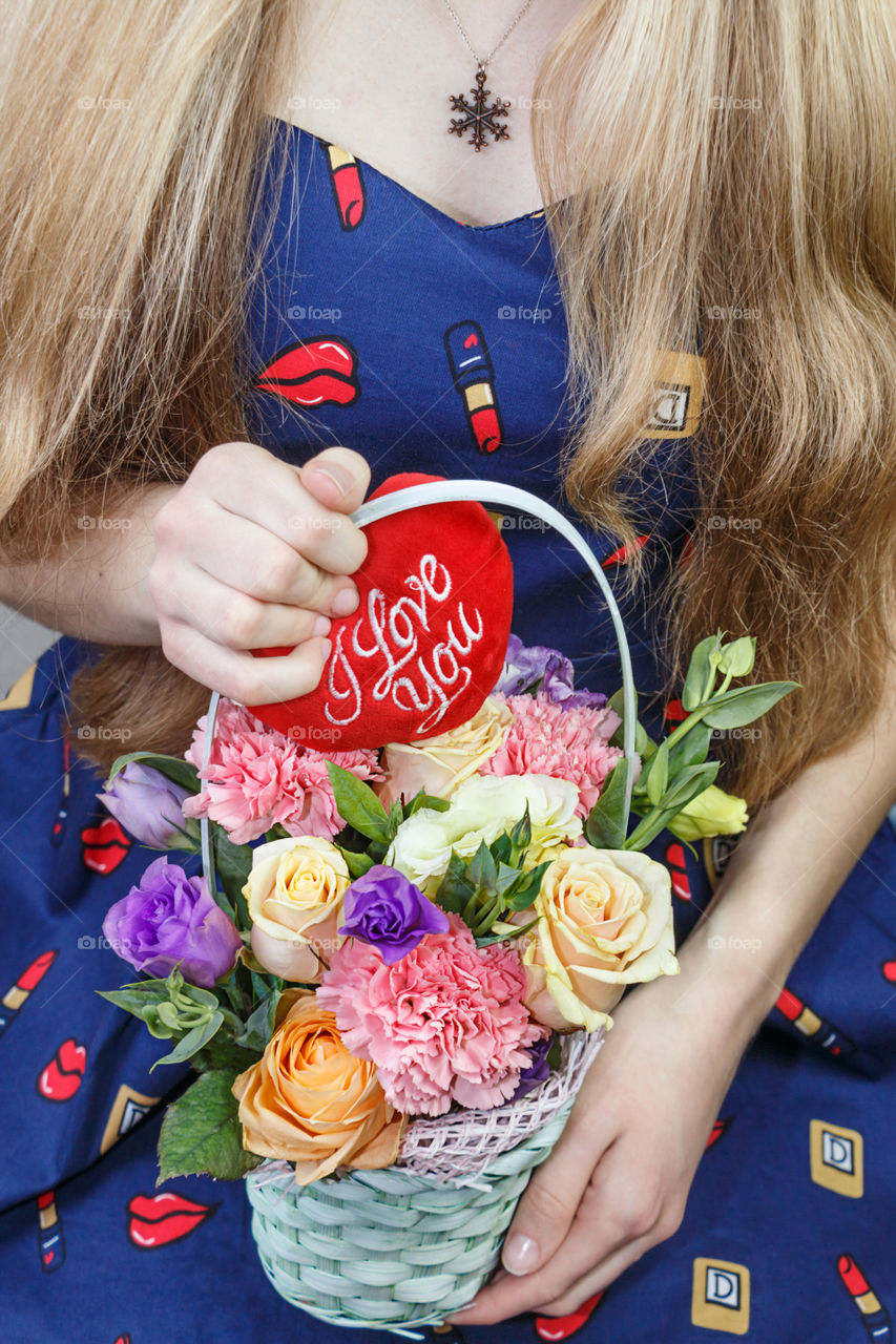 Girl with a basket of flowers