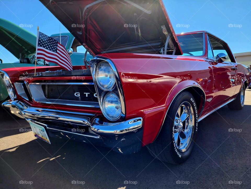 A Pontiac GTO muscle car in bright red is a dream car for many, including this photographer