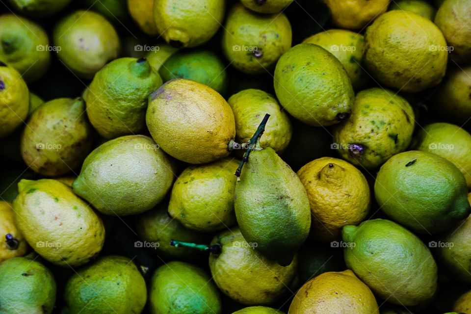 Green lemons in a box
