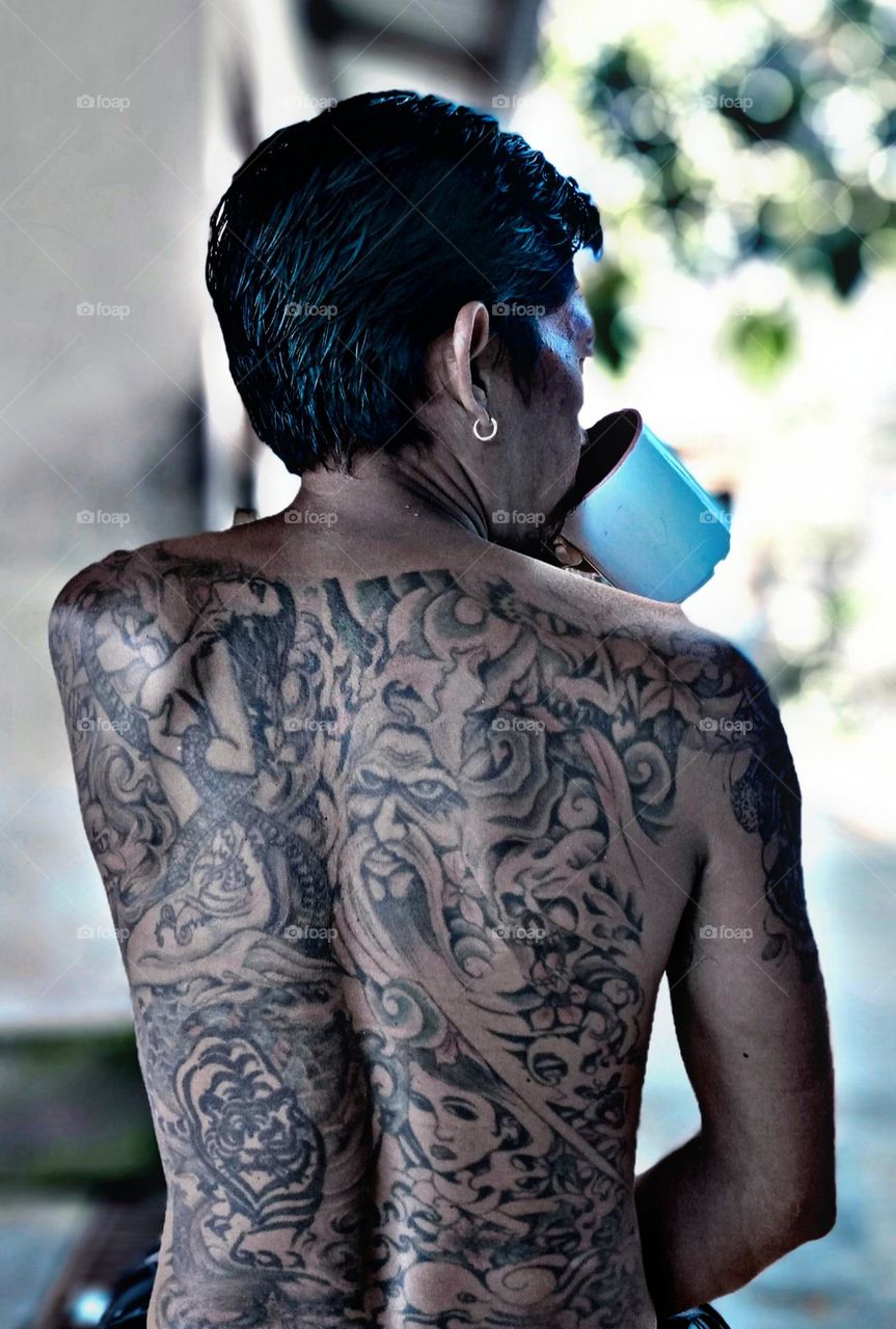 this is my uncle using a tattoo on his back