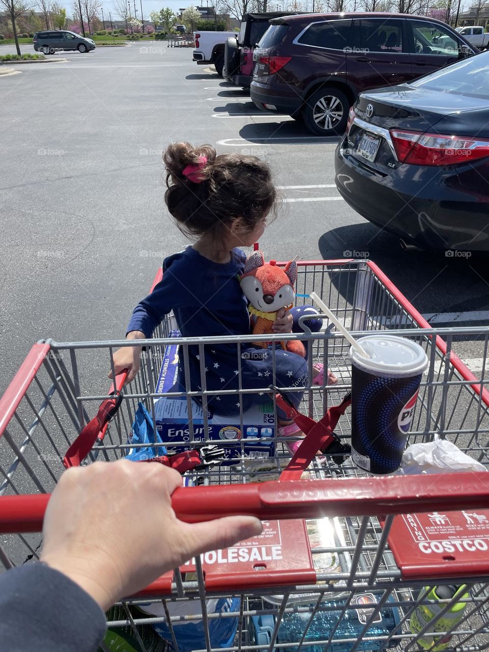 Mother pushes Costco cart, child rides in Costco cart, daily activities, daily shopping with toddlers, daily routines 