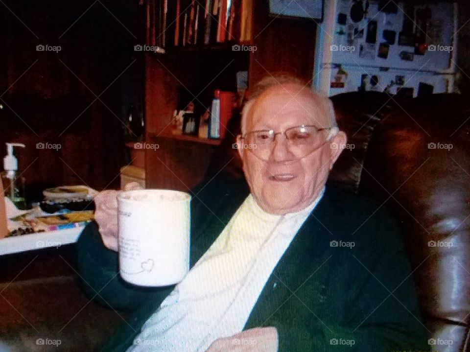 Drinking hot chocolate with an older person, grandfather. Oxygen being used.