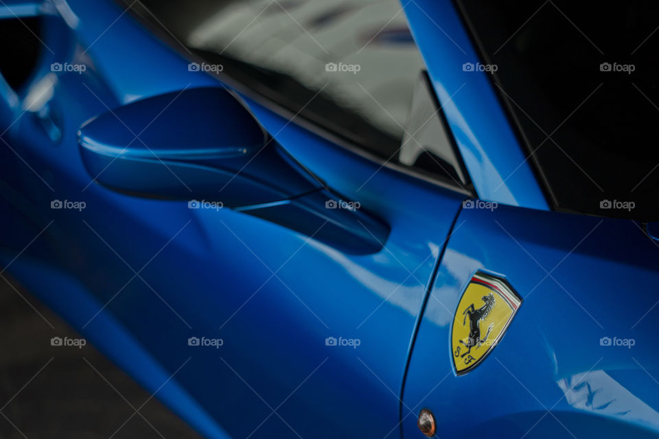 Blue Ferrari 488 spider coupe sports car 3.9 liter V8 twin turbo charged  (F154CB V8) close up side logo