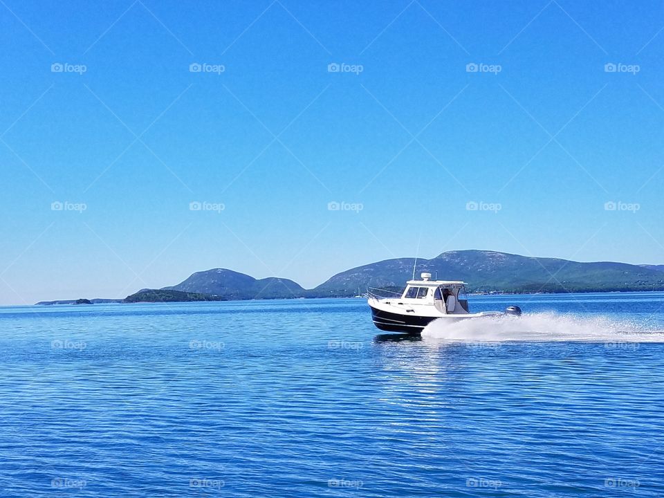 Eastern Powerboat With Acadia National Park In The Background