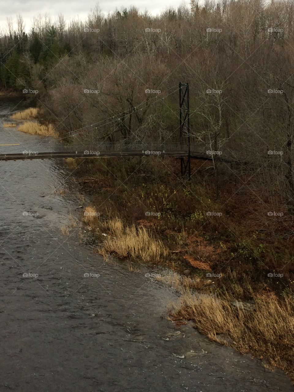ATV and walking bridge across the river 