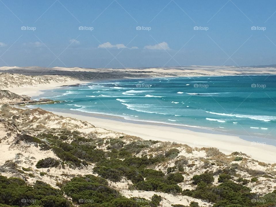 Sand dunes surrounding a remote pristine turquoise blue and white sand coastline in south Australia near Coffin Bay 