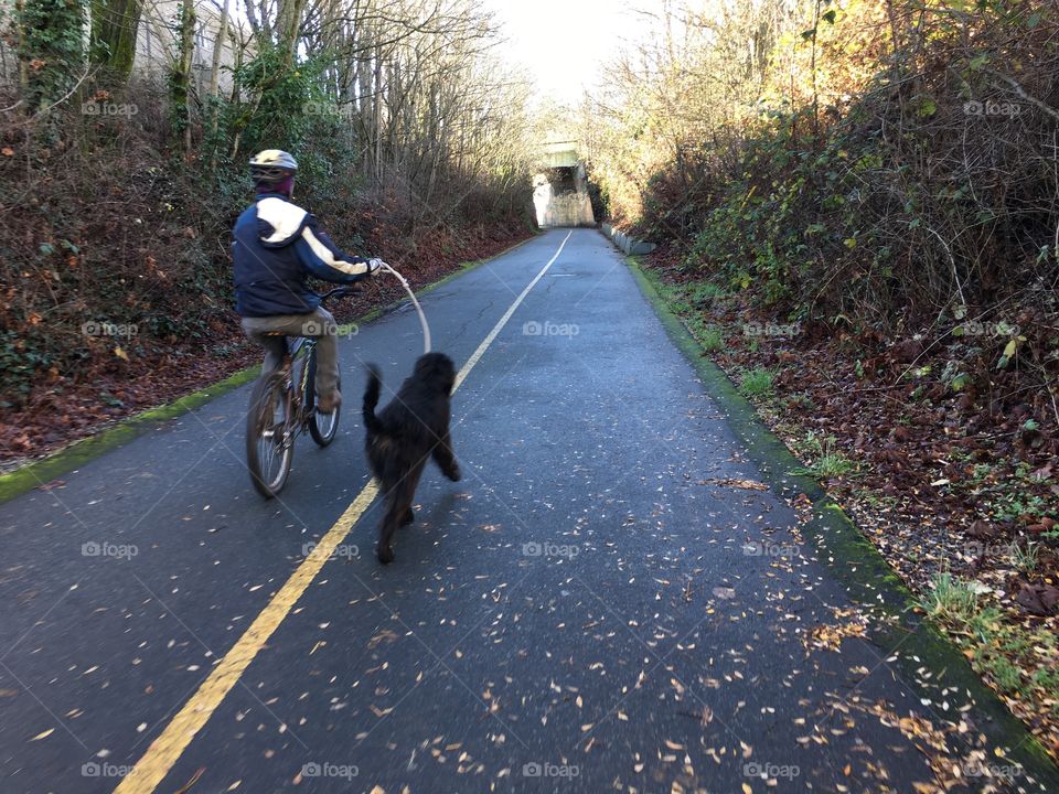 Biker walking his dog