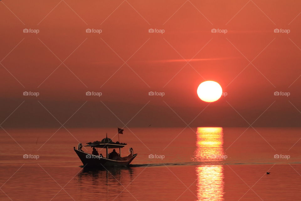 A tourist boat at sunset