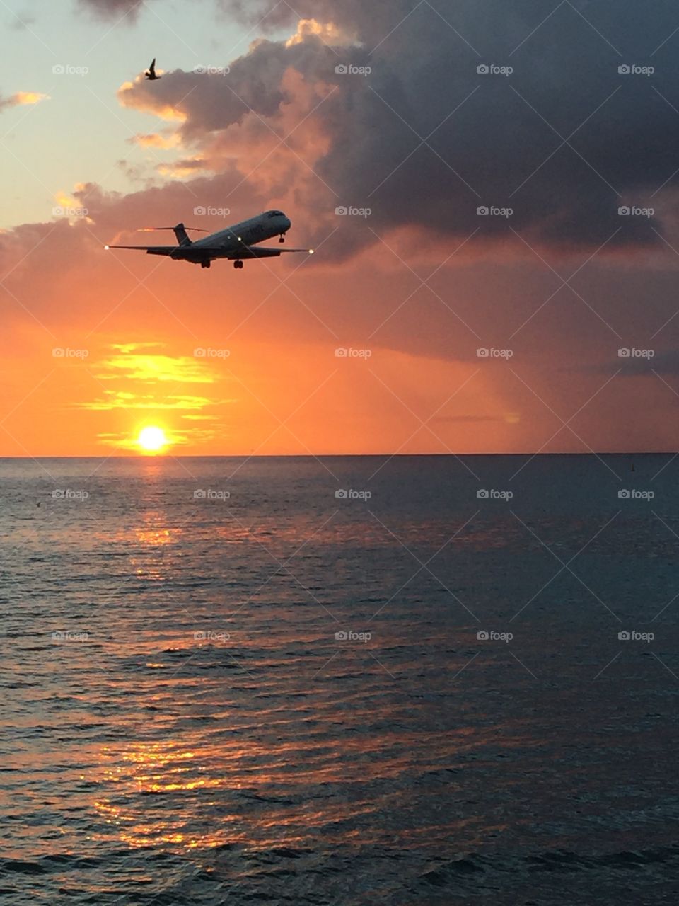 Sunset In St. Maarten On Maho Beach With Plane Landing, Sunset Over The Ocean, Reflections On The Water, Glow Of The Sunset, Plane Landing 