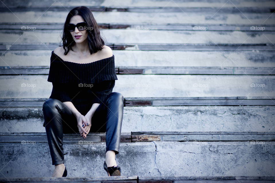 Woman sitting on staircase