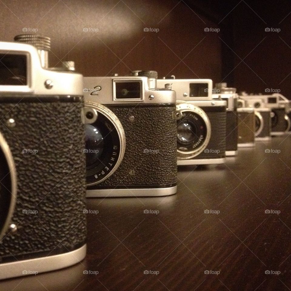 Old cameras . Some old cameras on a shelf Canon Zhenit Zorky Smena Leica 