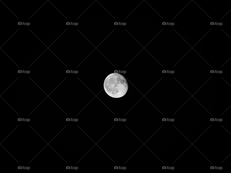 Big round circular sphere close up circle body of full white moon at dark night time clear sky on black background Seen through telescope. Planet universe astronomical galaxy space exploration concept