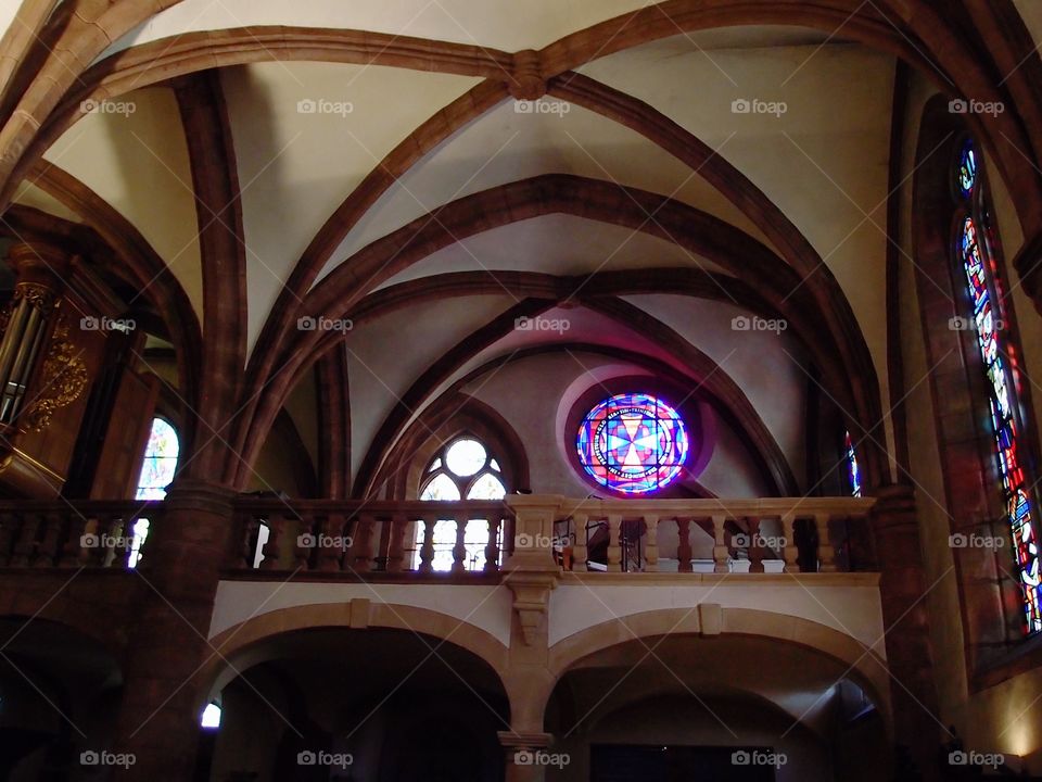 A beautiful stained glass window with vibrant colors in an old cathedral in Luxembourg. 