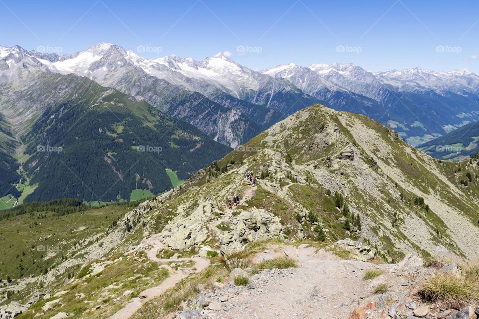 Hiking in the beautiful Spikeboden  mountains in the alps of Italy on a sunny summer day 