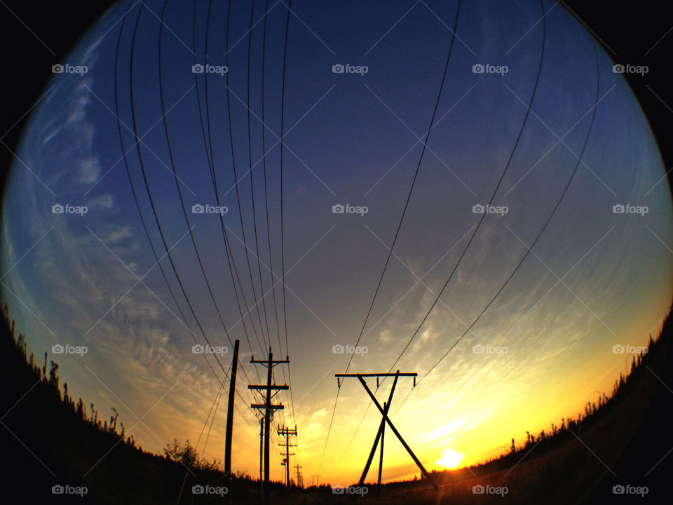 Midsummer sunset near power lines in Anchorage, Alaska.