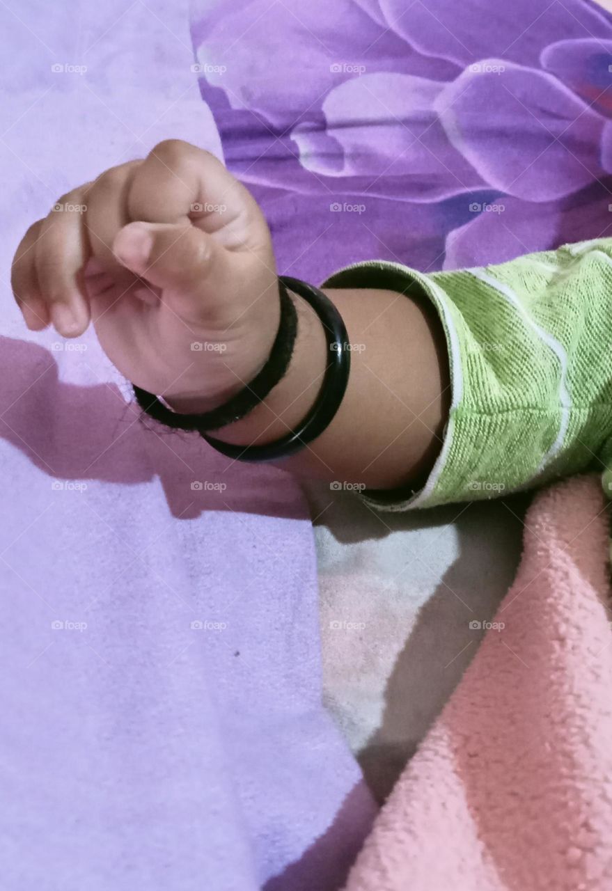 This beautiful ❤️😍 hand of two months baby girl 🐥😍. Baby is sleeping in her bed and playing joyfully with her toys!!🪀🧸