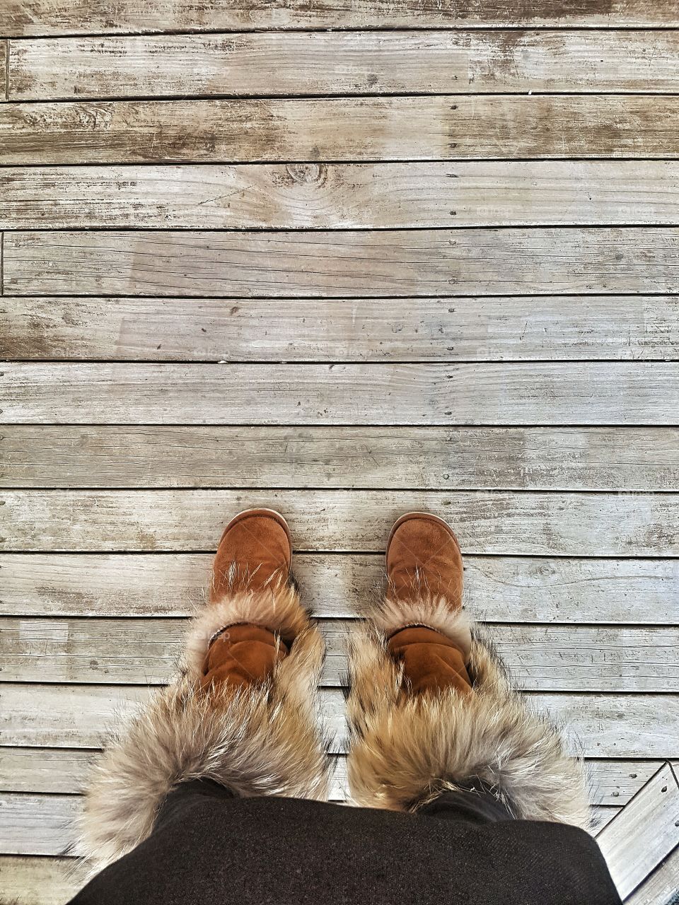 Ugg Boot slippers on wooden deck