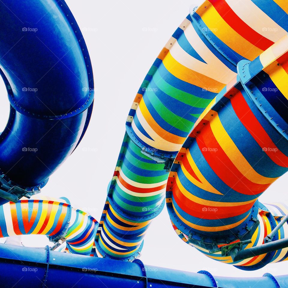 multi-colored striped vibrant tube slides in the water park