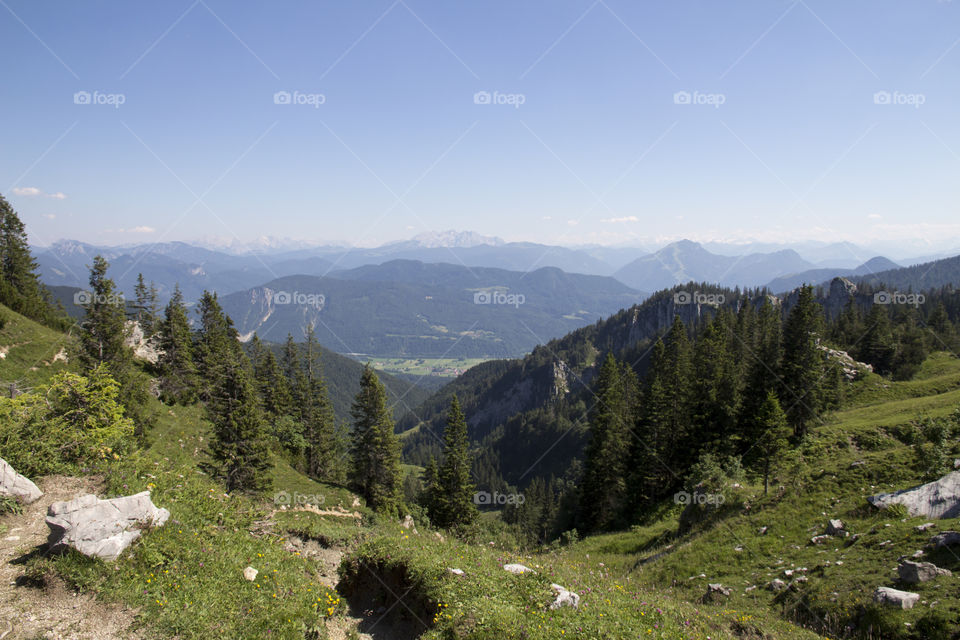 Hiking trail at high altitude in green mountains, panoramic view 