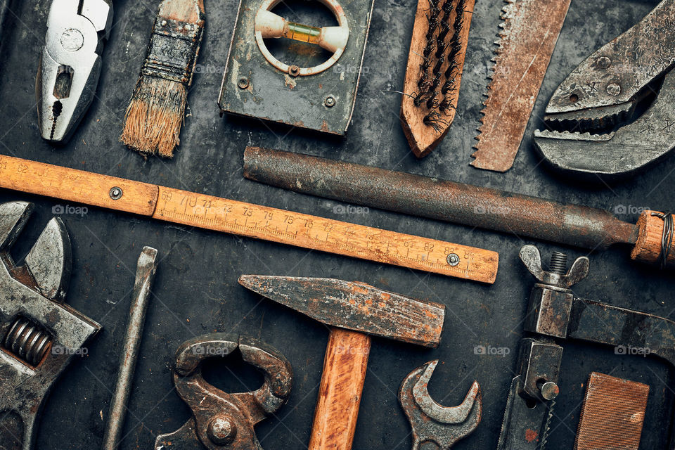 Old hardware tools. Wrench, screwdriver, measure, hammer, pliers on steel surface. Mechanic tools for maintenance. Hardware tools to fix. Technical background with copy space