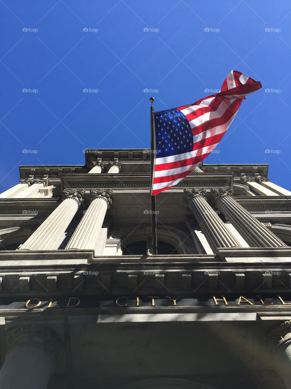 American flag on the Old City Hall building in Boston, Massachusetts, USA