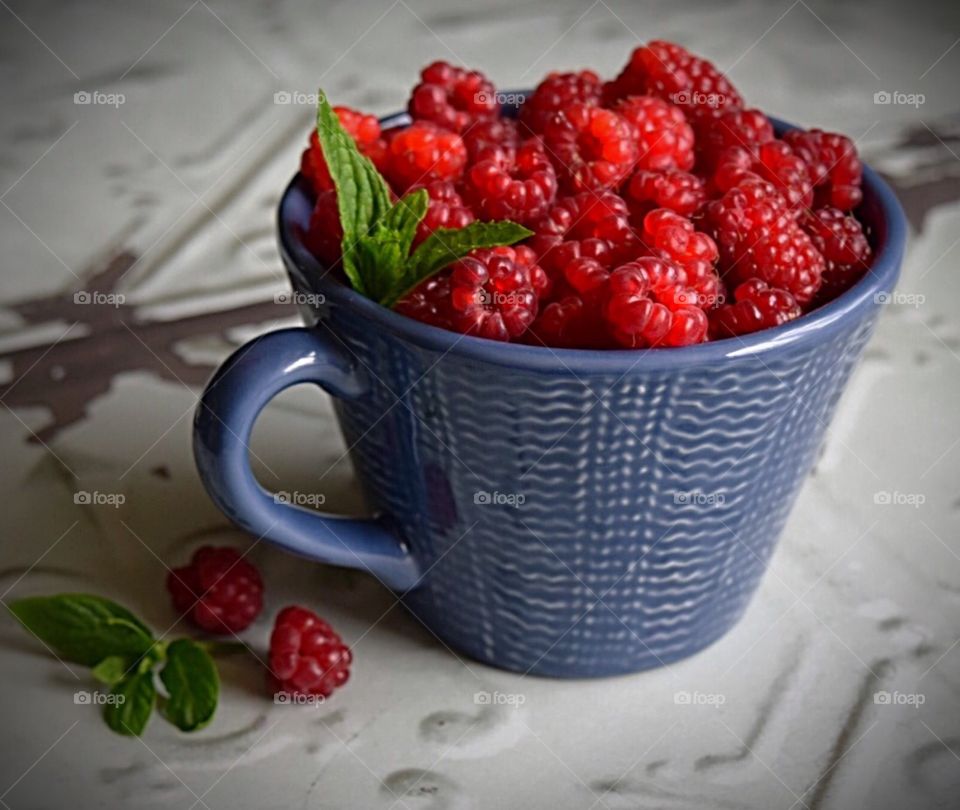Cup full of Homegrown organic  raspberries from my garden 