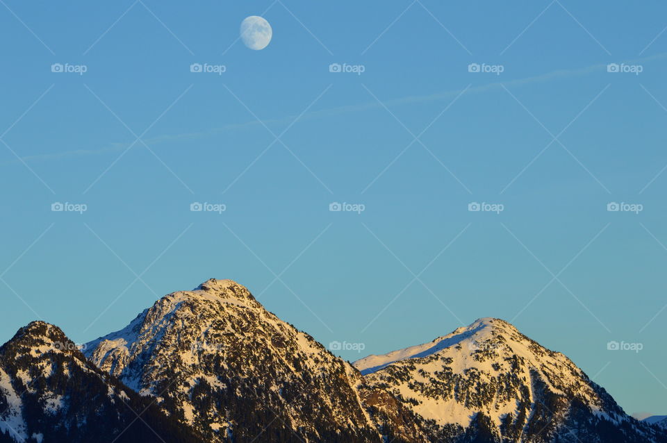 Moon rising over mountains 