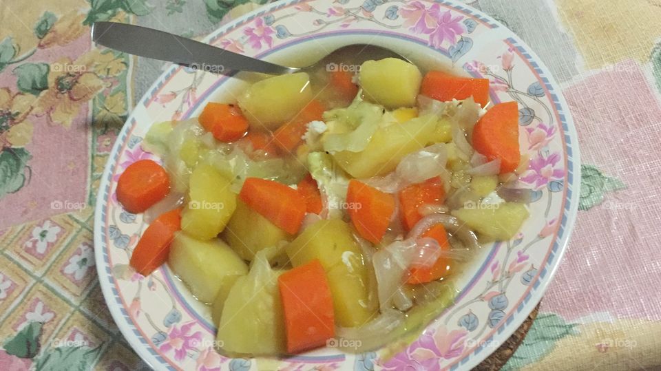 Potato, carrot, cabbage and onion stew with one poached egg