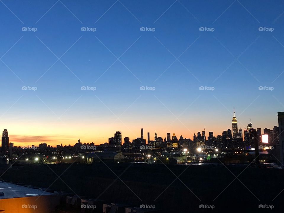 Sunset over the city that never sleeps New York. Beautiful sunset with the light just behind the busy city