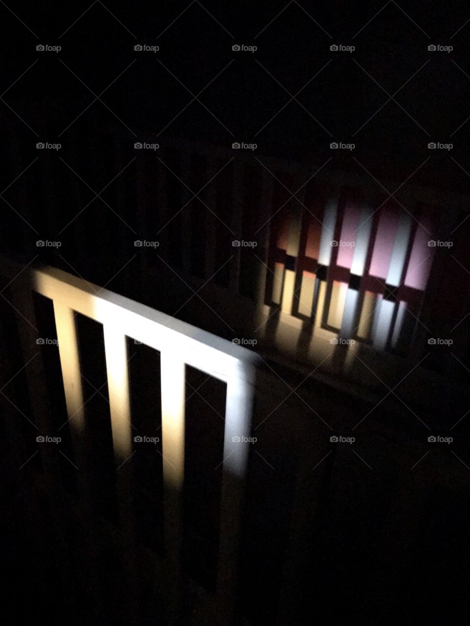 Light shining through crack in the door to baby crib