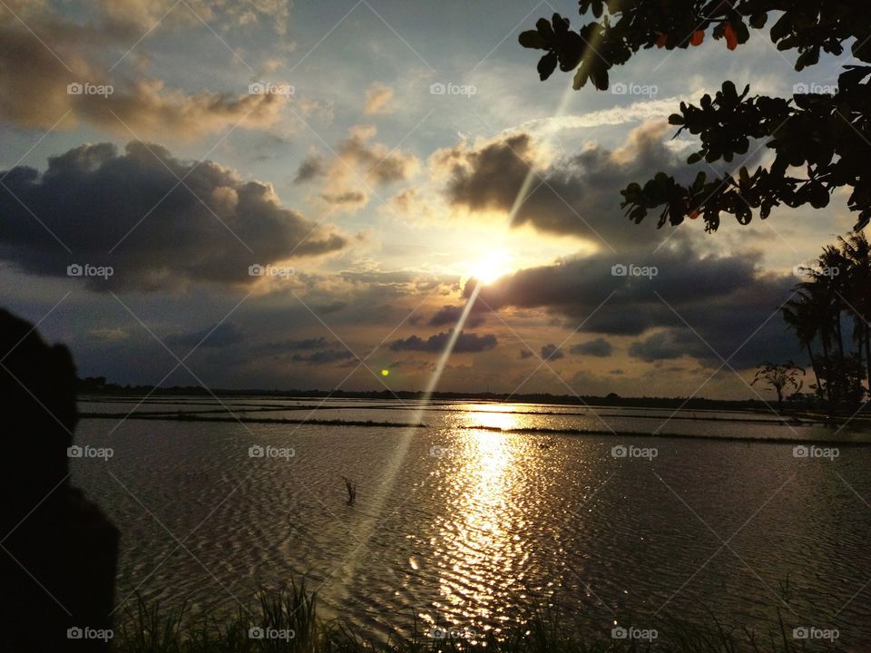 sunset view with the sun that will be covered by black clouds