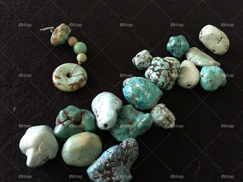 Turquoise beads on black background 