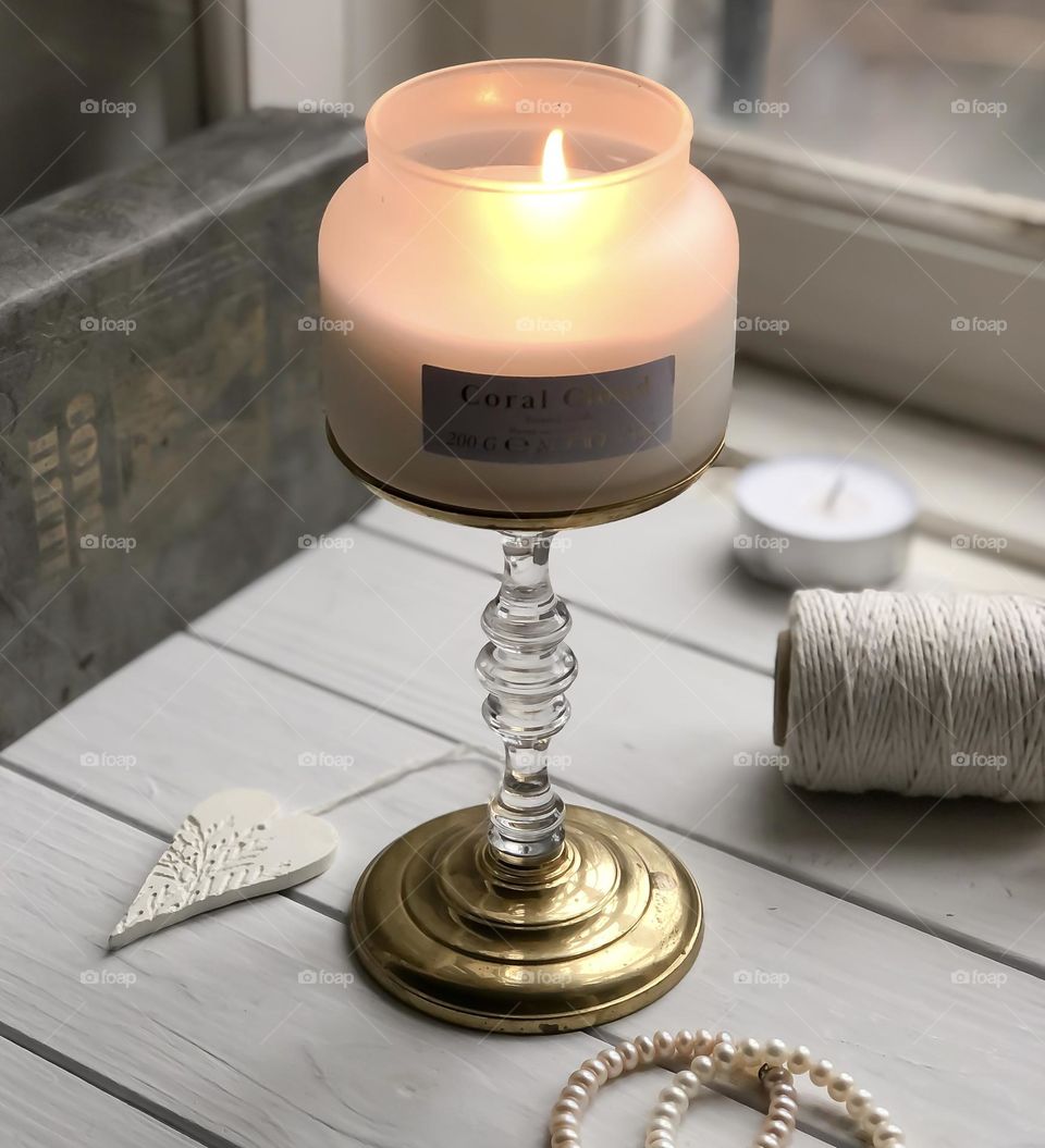 Arrangement with vintage candlestick and candle