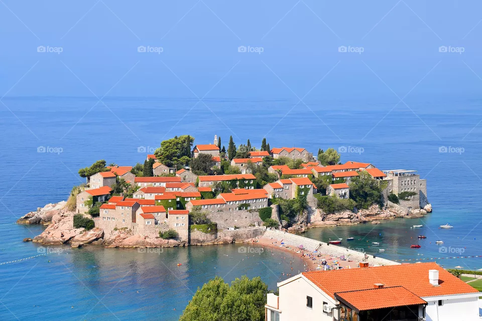The picturesque island of Sveti Stefan on a hot summer day. Budva, Montenegro